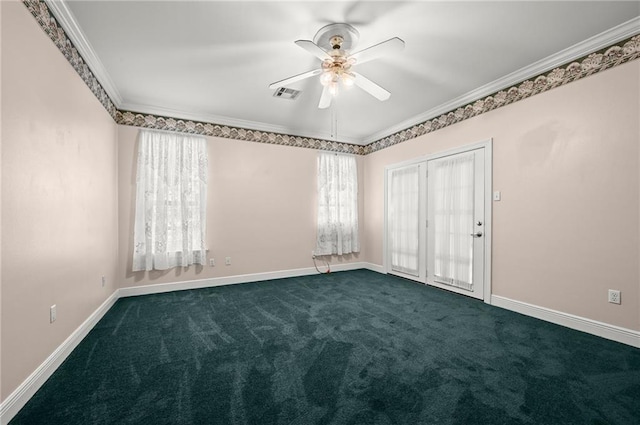 empty room with ceiling fan, dark carpet, and ornamental molding