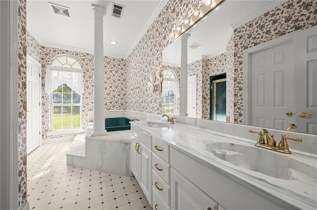 41298 Baytown Rd, Hammond, LA 70403 - bathroom featuring ornamental molding, wallpapered walls, ornate columns, double vanity, and a garden tub