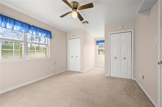 41298 Baytown Rd, Hammond, LA 70403 - unfurnished bedroom featuring two closets, light carpet, and ceiling fan