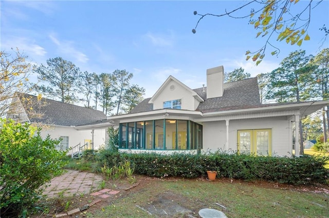 back of house with a sunroom