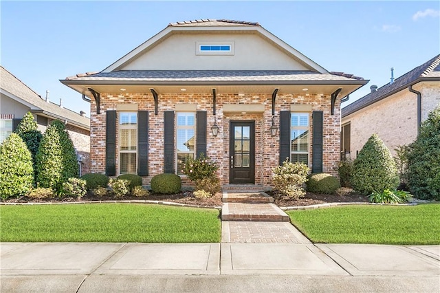 view of front facade with a front yard and a porch