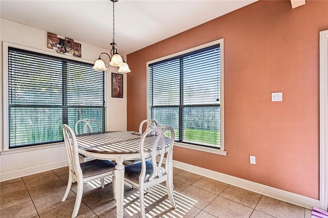 dining room featuring tile patterned floors and an inviting chandelier