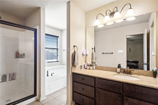 bathroom featuring plus walk in shower, vanity, and tile patterned floors