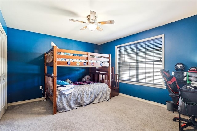 carpeted bedroom featuring a closet and ceiling fan