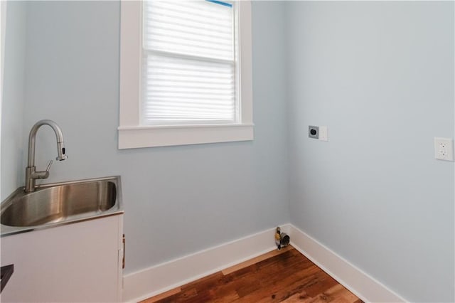 laundry area featuring sink, hardwood / wood-style floors, and hookup for an electric dryer