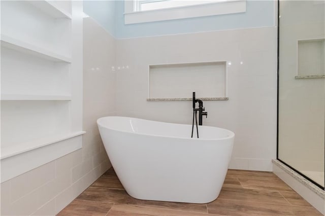 bathroom featuring hardwood / wood-style flooring and independent shower and bath