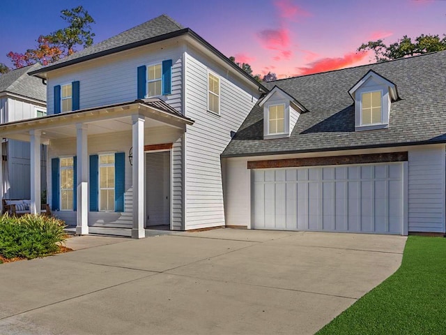 view of front facade featuring a porch and a garage