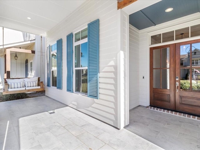 entrance to property featuring french doors and covered porch