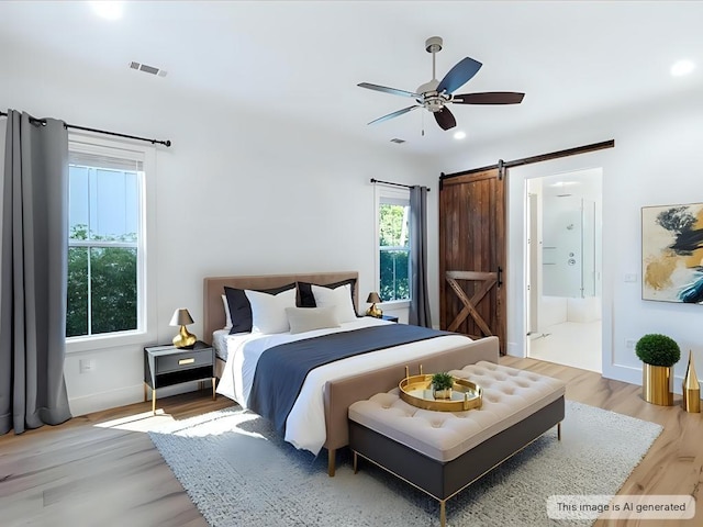 bedroom with a barn door, baseboards, a ceiling fan, connected bathroom, and light wood-style flooring