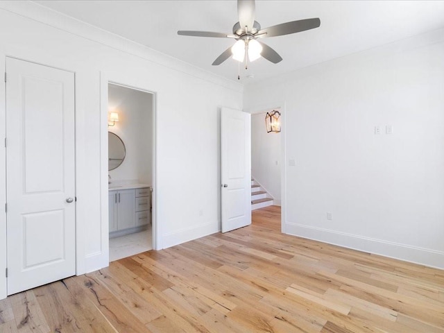 unfurnished bedroom featuring ensuite bathroom, ceiling fan, ornamental molding, and light wood-type flooring