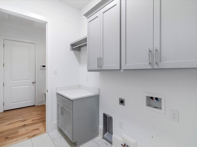 clothes washing area with washer hookup, baseboards, marble finish floor, cabinet space, and electric dryer hookup