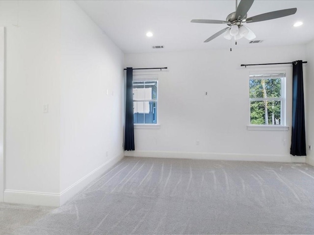 spare room featuring recessed lighting, baseboards, visible vents, and light colored carpet