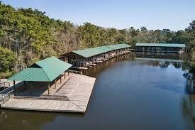 dock area with a wooded view and a water view