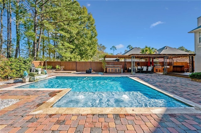 view of swimming pool featuring a patio area and a jacuzzi