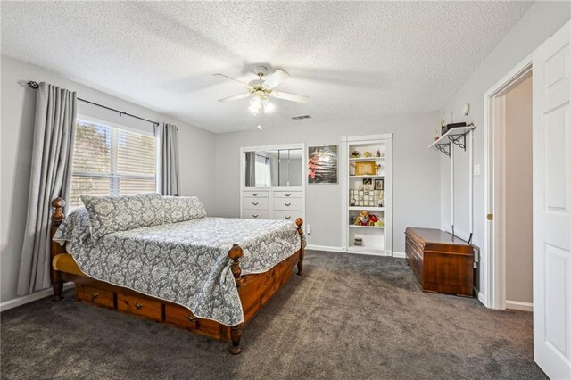 carpeted bedroom with a textured ceiling and ceiling fan