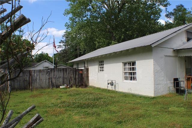 view of side of home featuring a lawn