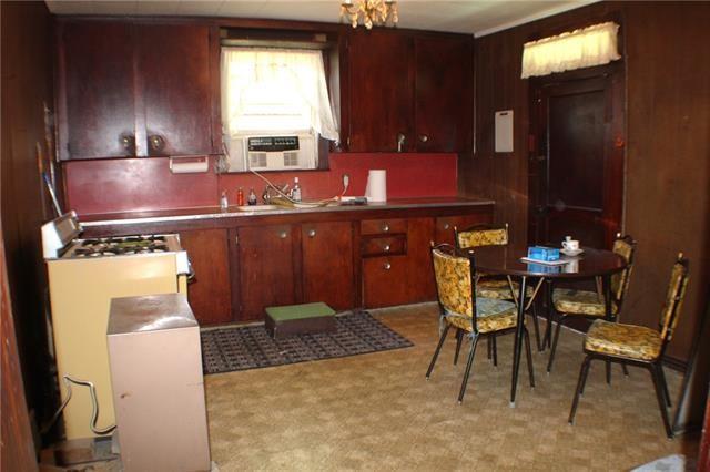 kitchen featuring light colored carpet, cooling unit, and sink