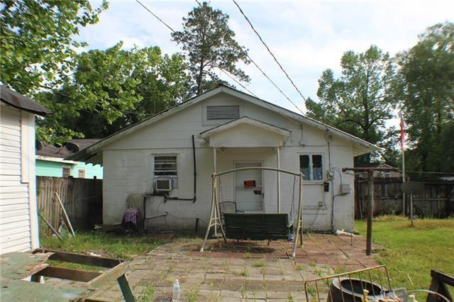 rear view of house with a yard and a patio