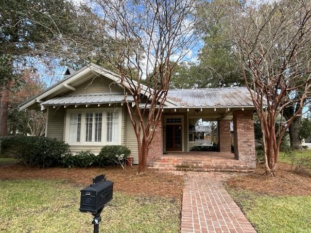 bungalow with a porch and a front yard