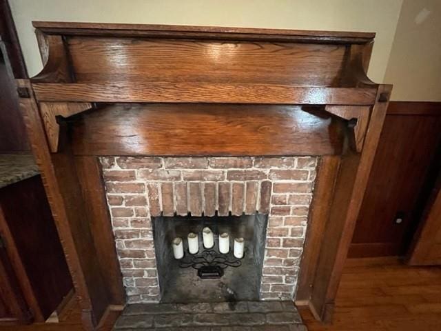 room details featuring a fireplace and hardwood / wood-style flooring