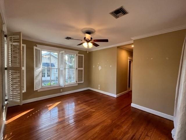 unfurnished room with ceiling fan, ornamental molding, and dark wood-type flooring