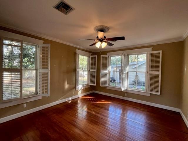 empty room featuring a wealth of natural light and dark wood-type flooring