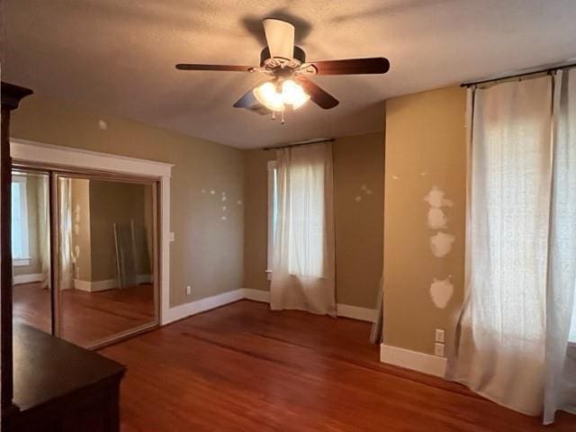 empty room with hardwood / wood-style floors and ceiling fan