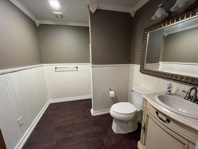 bathroom featuring hardwood / wood-style flooring, toilet, vanity, and ornamental molding