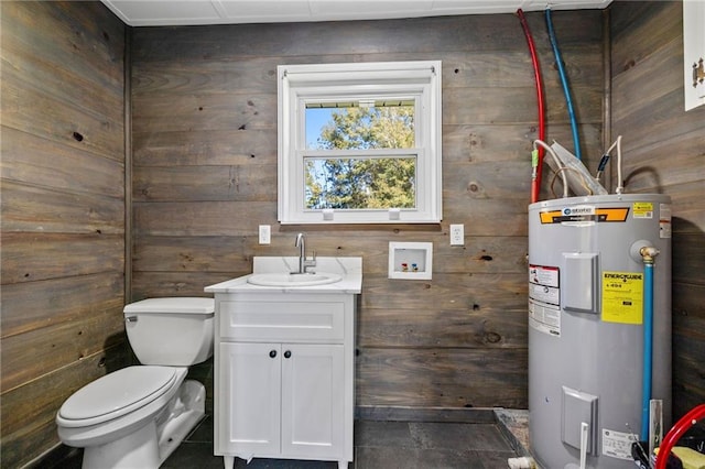 bathroom with vanity, toilet, wooden walls, and water heater