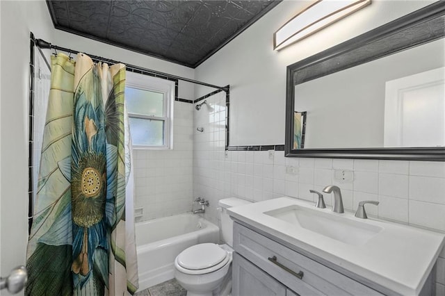 full bathroom featuring shower / bath combo, vanity, toilet, and tile walls