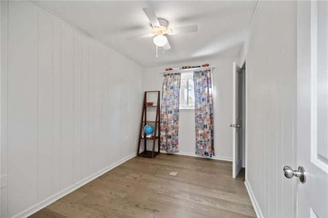 unfurnished room with ceiling fan and light wood-type flooring