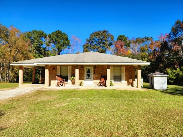 view of front facade with a front yard and a shed