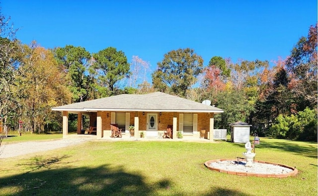 view of front of home featuring a storage unit, a porch, and a front yard