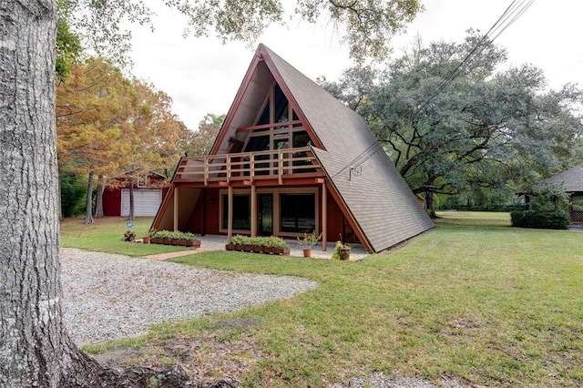 rear view of property featuring a yard, a shed, and a wooden deck