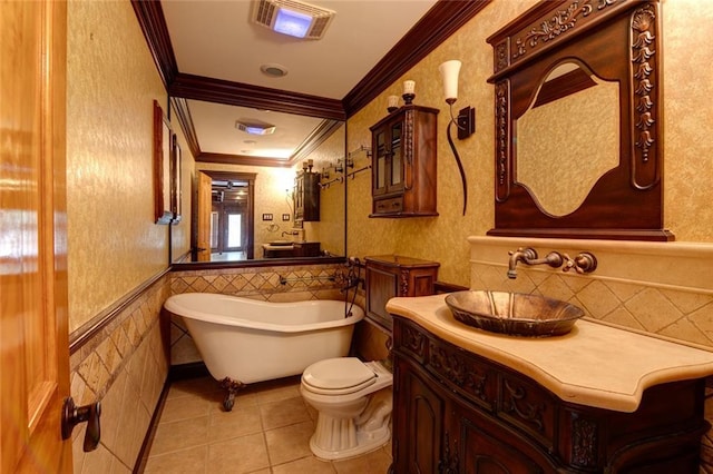 248 Chateau Dr, Slidell, LA 70460 - bathroom featuring vanity, tile patterned floors, a washtub, ornamental molding, and tile walls