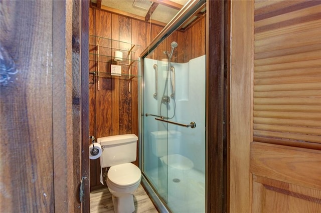 248 Chateau Dr, Slidell, LA 70460 - bathroom featuring hardwood / wood-style floors, toilet, and an enclosed shower
