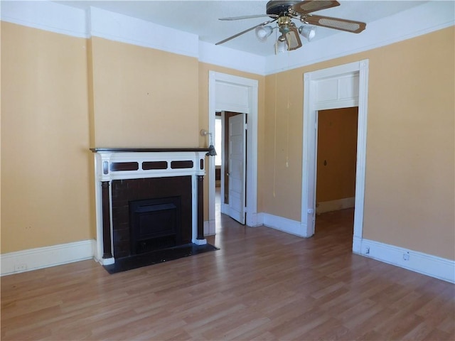 unfurnished living room featuring hardwood / wood-style flooring and ceiling fan