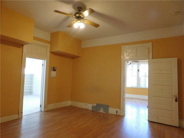 empty room featuring ceiling fan and light wood-type flooring