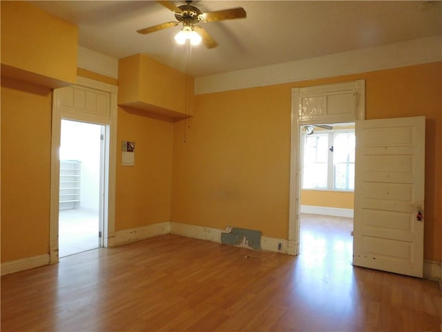 unfurnished room featuring ceiling fan and light hardwood / wood-style flooring