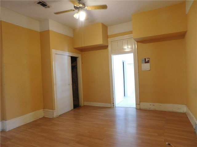 spare room with ceiling fan and light hardwood / wood-style floors