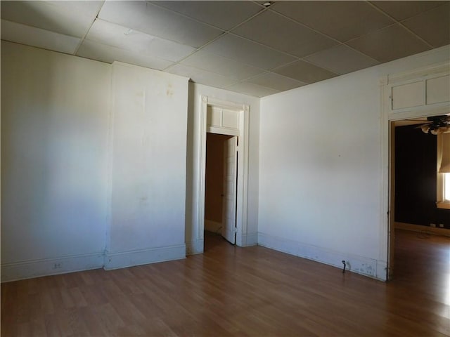 unfurnished room featuring a paneled ceiling and wood-type flooring