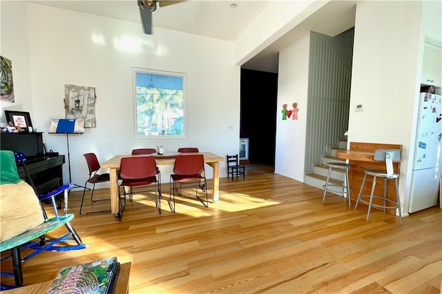 dining area featuring light hardwood / wood-style flooring and ceiling fan