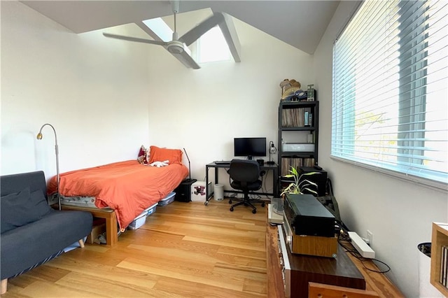 bedroom featuring ceiling fan, wood-type flooring, and vaulted ceiling