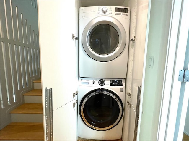 laundry room with stacked washing maching and dryer