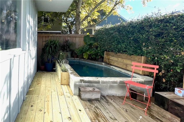 view of swimming pool featuring a wooden deck