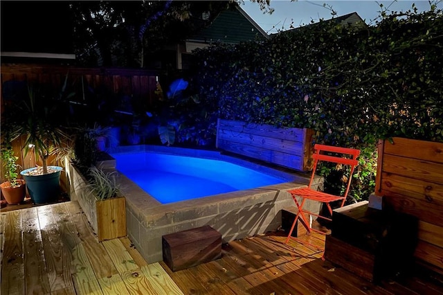 view of swimming pool with a jacuzzi and a wooden deck