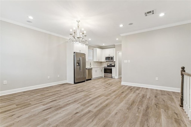 1908-10 St Louis St, New Orleans, LA 70112 - kitchen with stainless steel appliances, crown molding, a chandelier, open floor plan, and light countertops