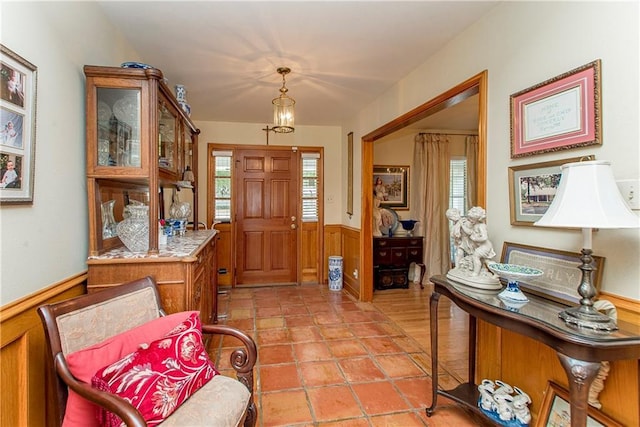 foyer featuring plenty of natural light and wooden walls