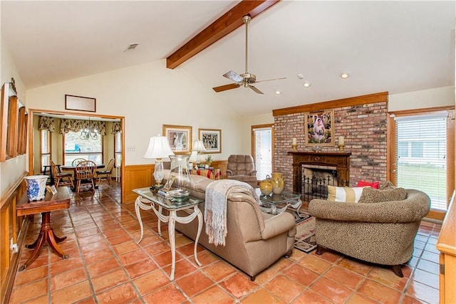 living room with a fireplace, lofted ceiling with beams, and ceiling fan