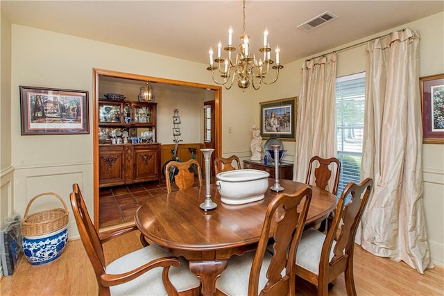 dining area featuring a chandelier and light hardwood / wood-style flooring